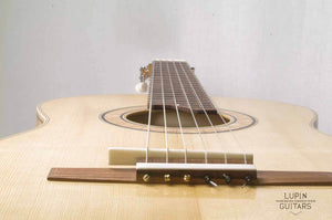 Spruce top classical guitar bridge